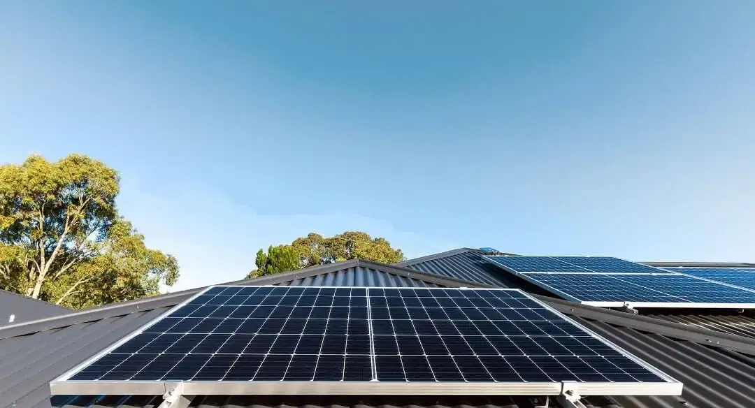 Close-up of solar panels with the sky reflected