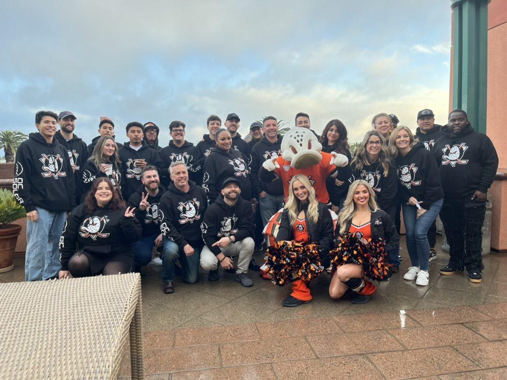 The OC Solar team with Wild Wing and the Anaheim Ducks cheer team