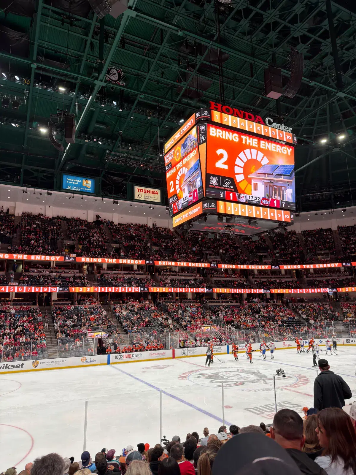 Interior of Honda Center showing the scoreboard jumbotron, crowd, and ice rink during a Ducks game.