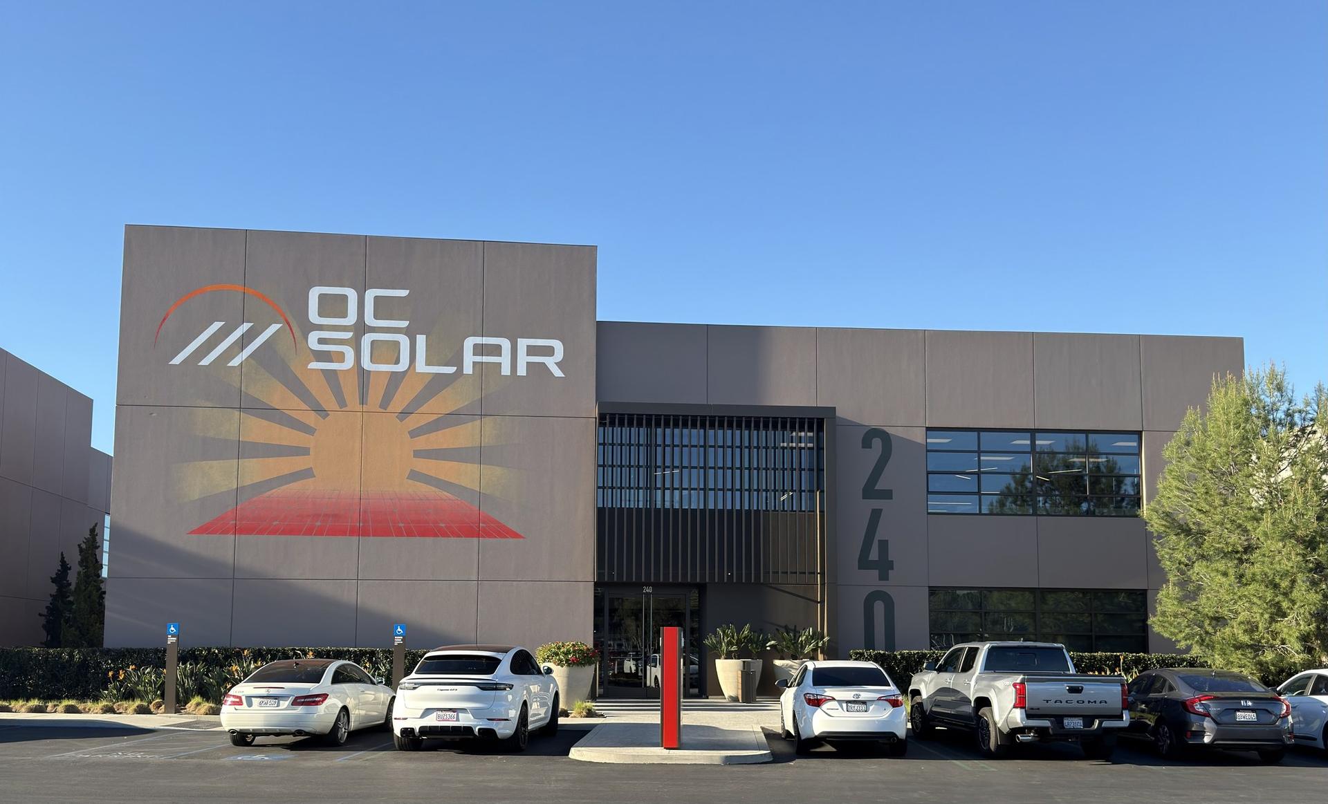 OC Solar headquarters building at 240 Progress in Irvine, California, with the sunburst logo mural on its front wall