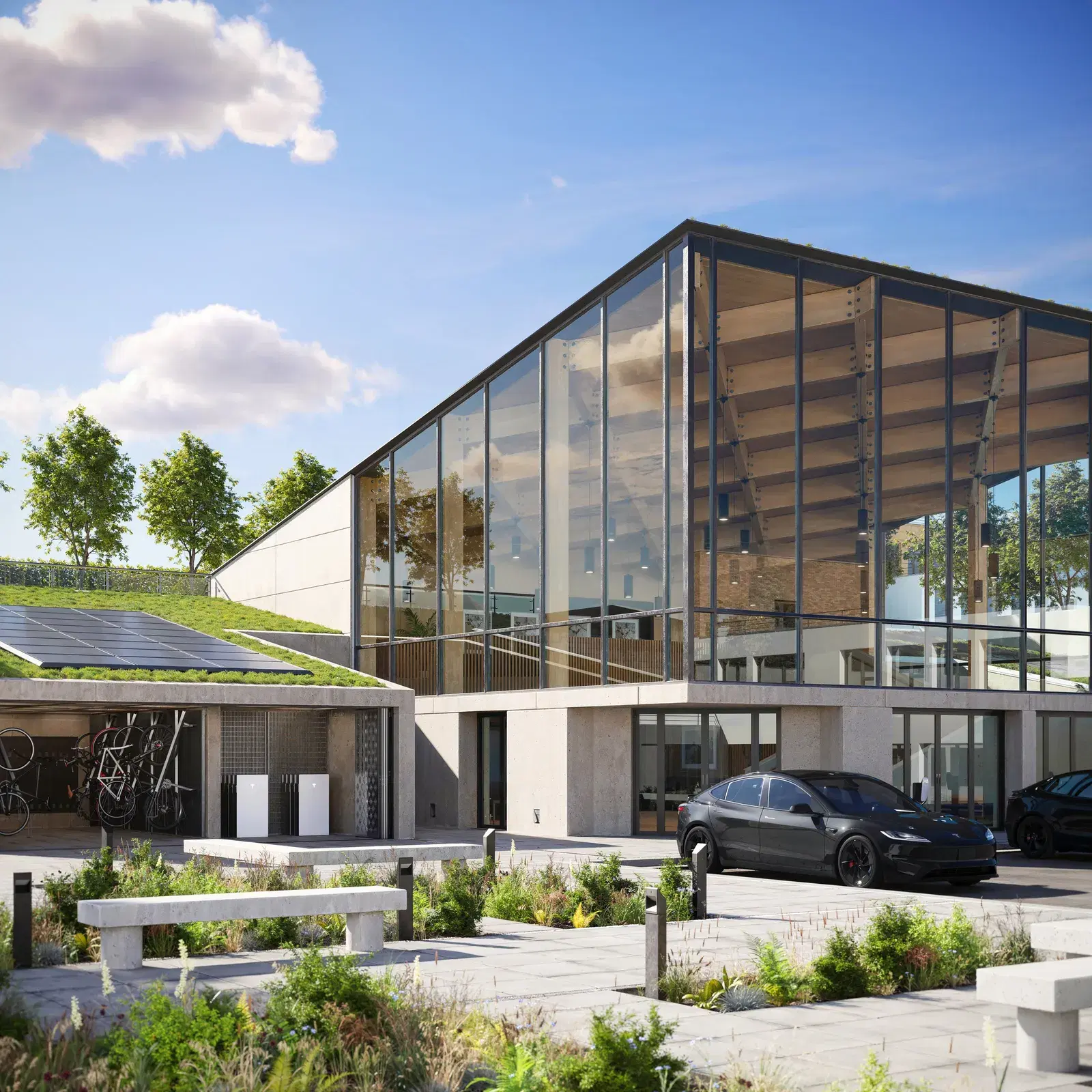 Modern glass-walled home at golden hour with two white Tesla Powerwall batteries mounted under a solar-paneled carport, Tesla vehicles parked in the driveway.
