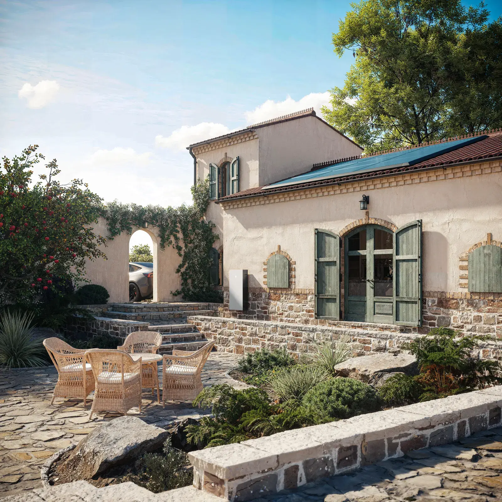 Rustic Mediterranean home with green shutters and solar panels on its tile roof, set above stone garden terraces.