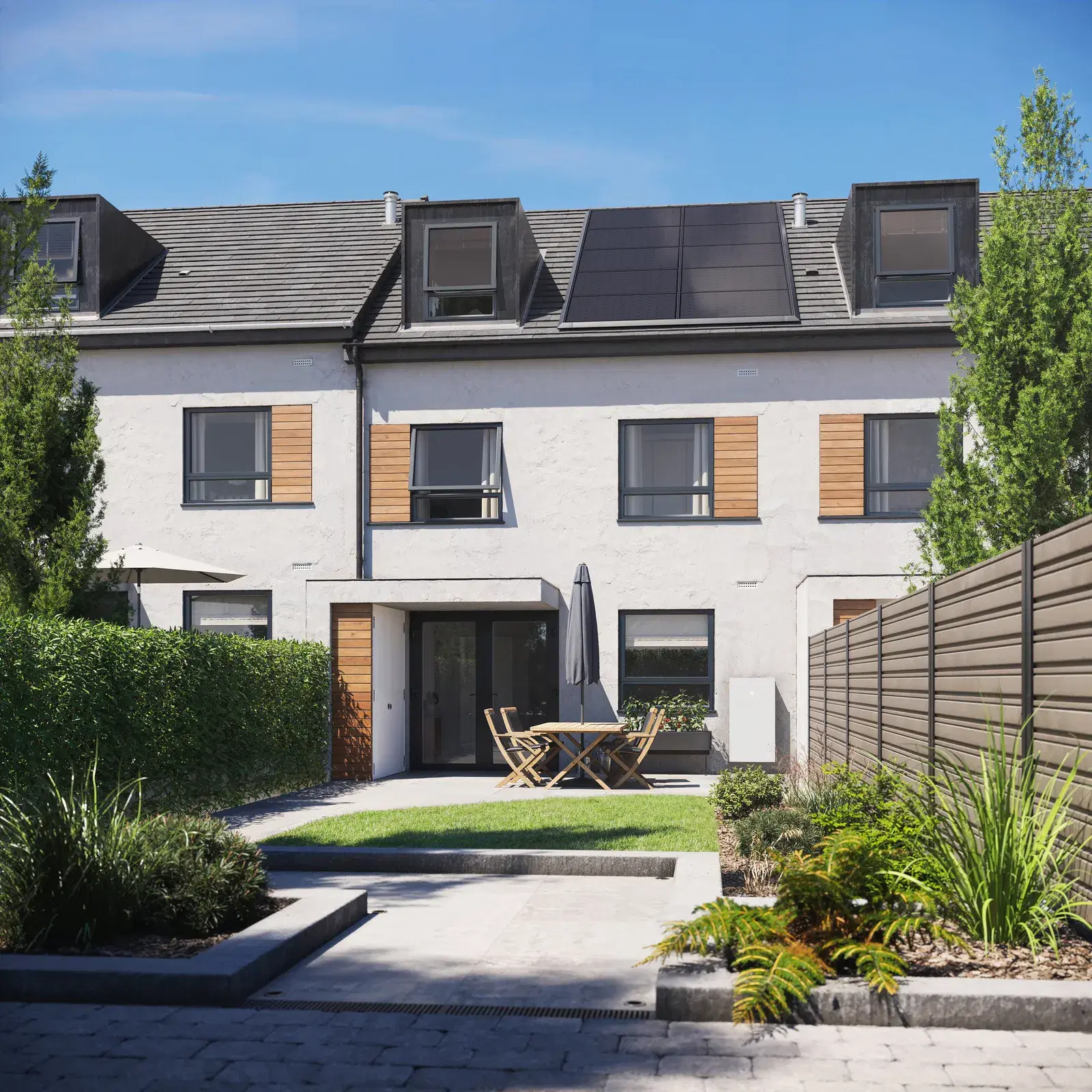 Three-story white townhouse on a sunny day with dark solar panels on its slate roof and a small white battery unit at ground level on the right.