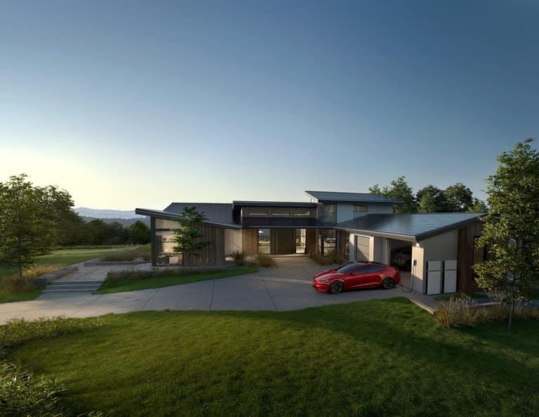 A pair of Tesla Powerwall home batteries mounted on the exterior wall of a modern Southern California home