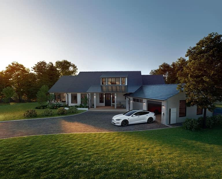 A home with a Tesla Solar Roof of tempered-glass solar tiles photographed at dusk