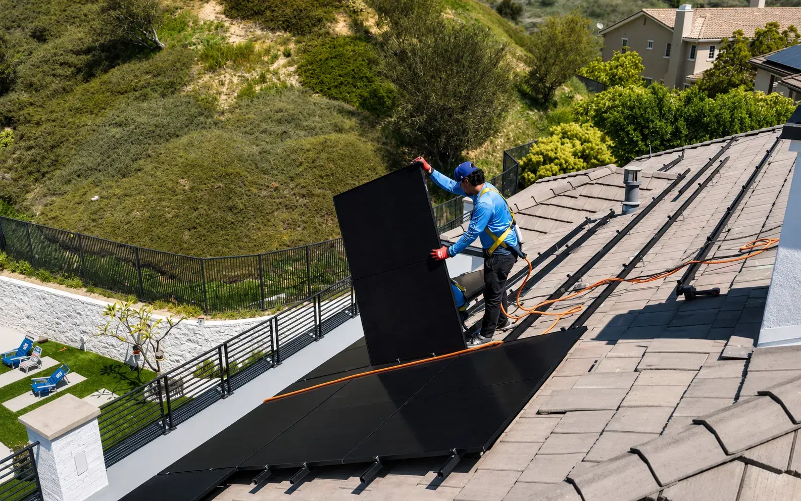 Solar panels being set on a concrete tile roof — the roof type most common on the 1990s-and-newer homes across the Inland Empire's Temecula, Murrieta, Corona, and Ontario neighborhoods