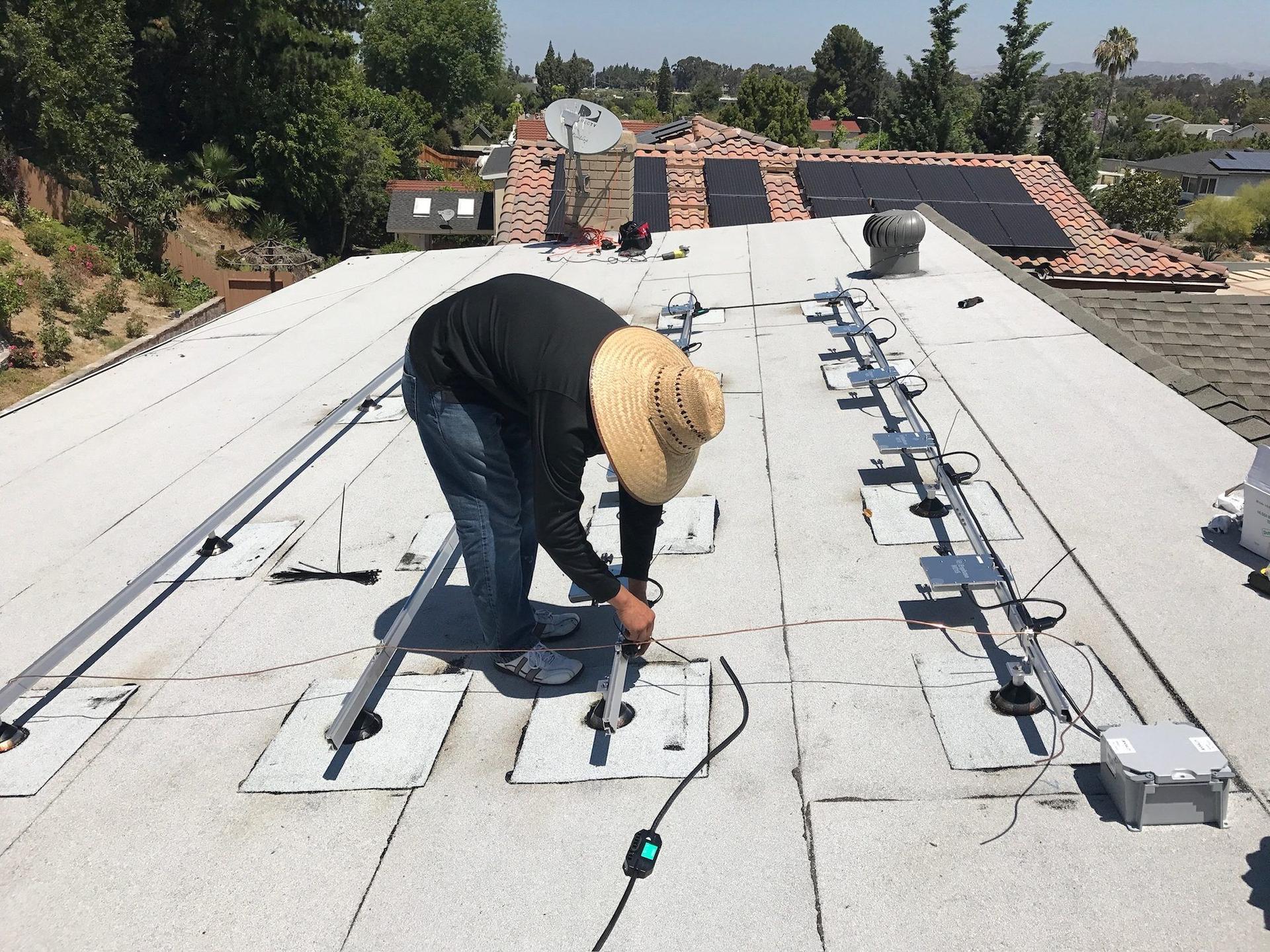 Installer's-eye view of solar panel rail mounting on a Southern California roof