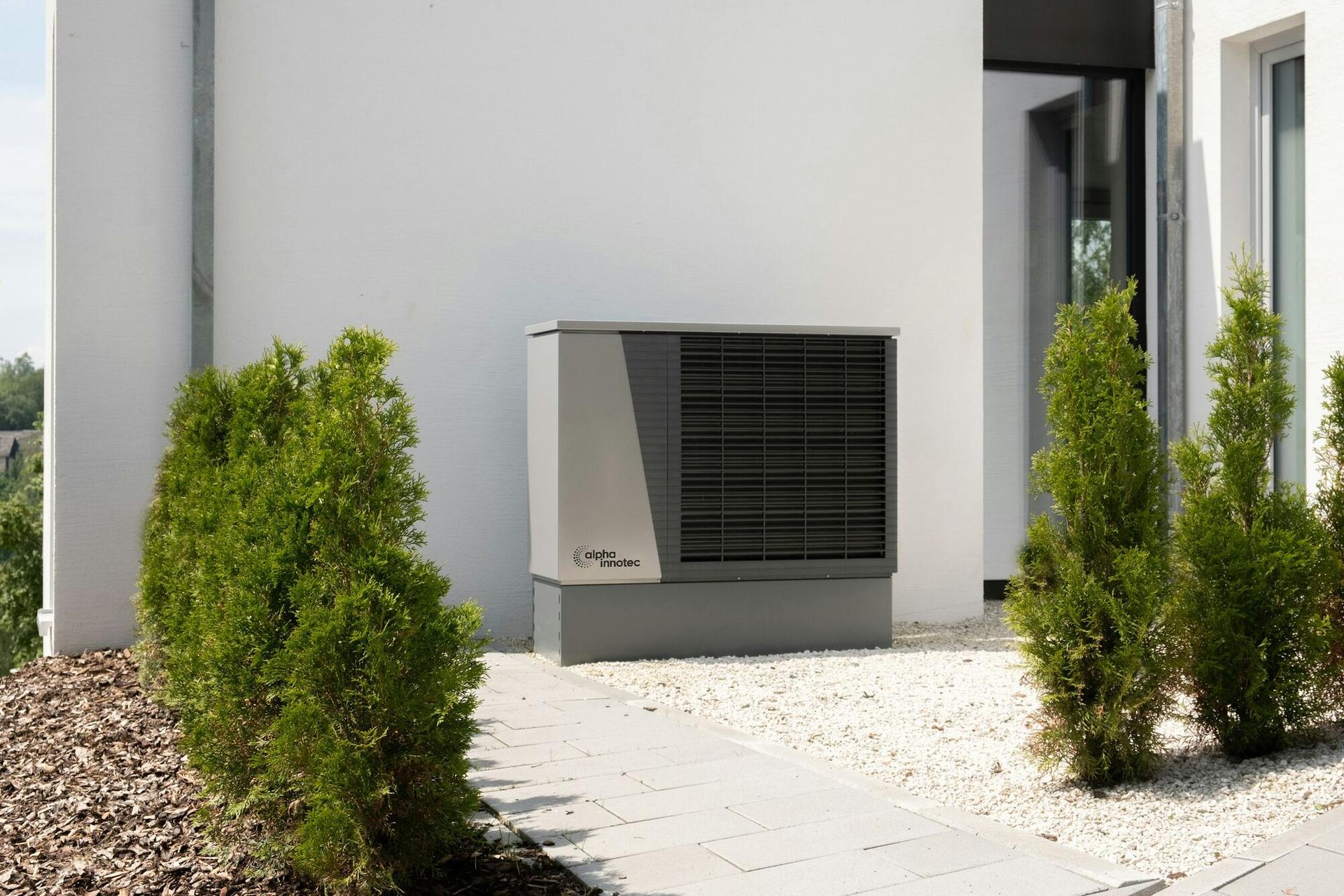 A high-efficiency heat pump unit installed beside a modern home (illustrative)