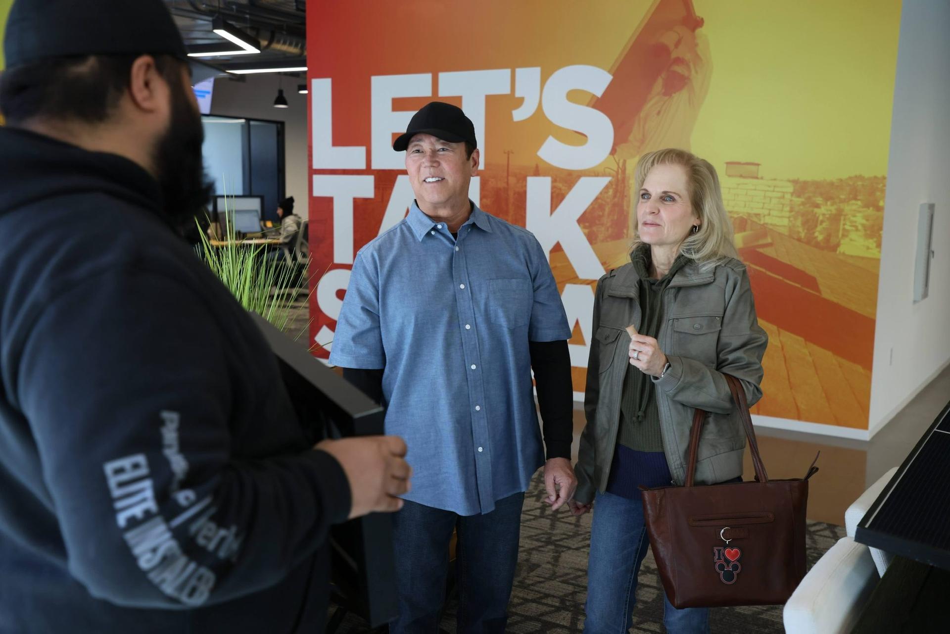 An OC Solar advisor walking homeowners through their solar plan at the Irvine showroom