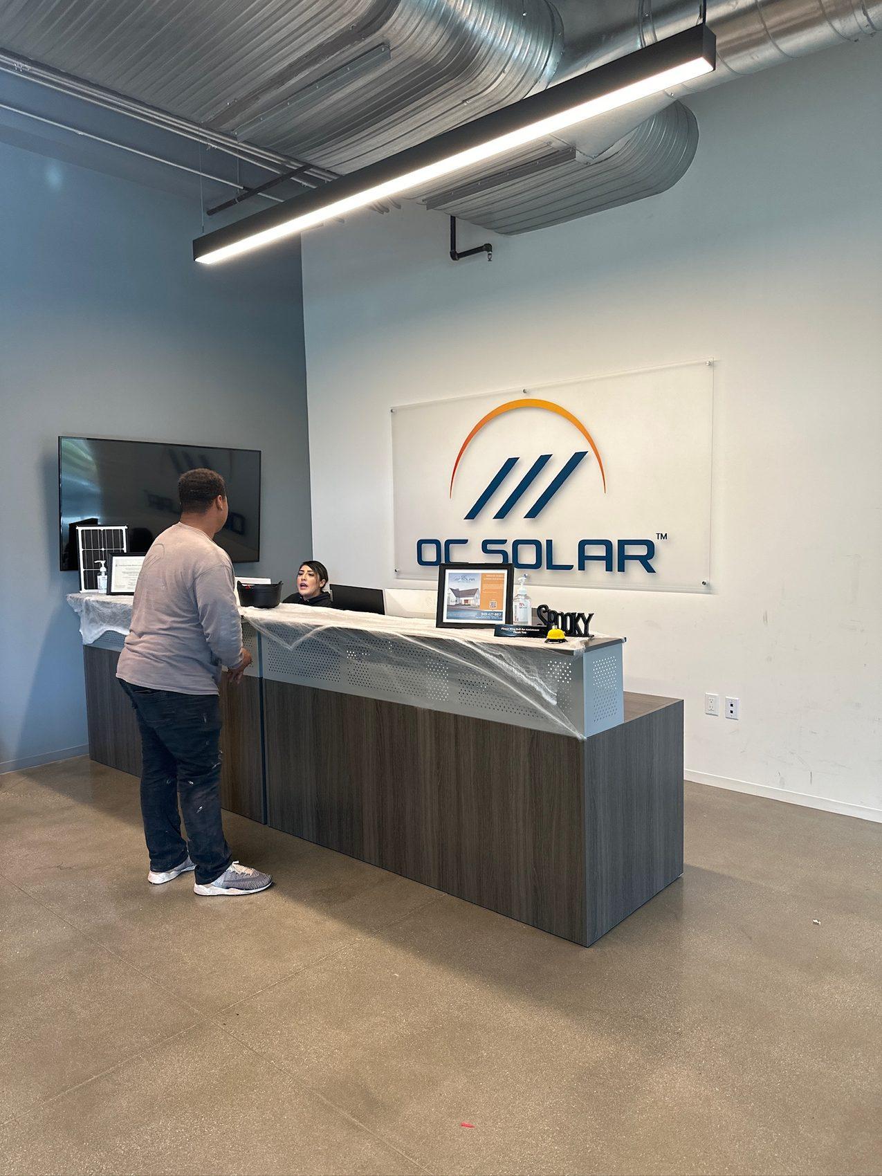 OC Solar team members at the reception desk of our Southern California office