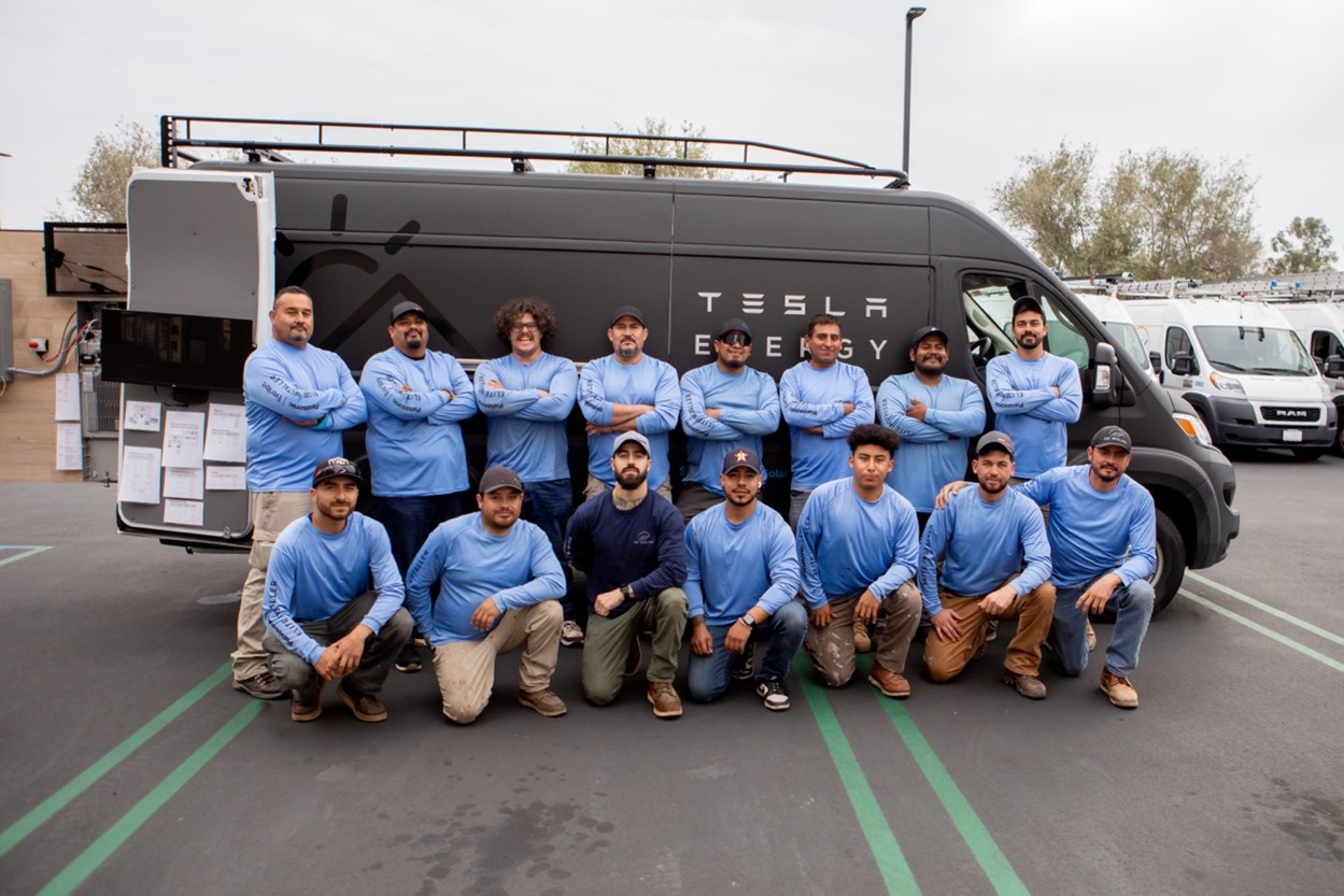 Team in front of Tesla Energy van
