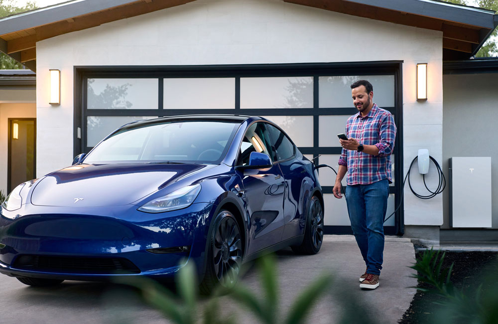 a Tesla owner unlocks his vehicle after charging with a Powerwall 3