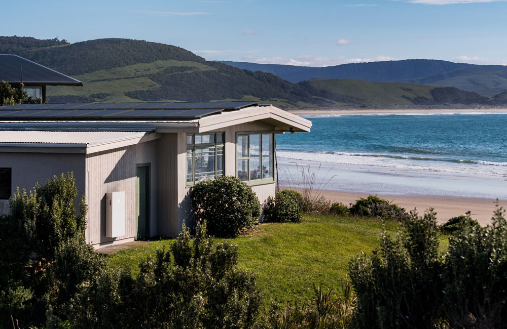 a house with a Tesla Powerwall 3 installed on its exterior façade