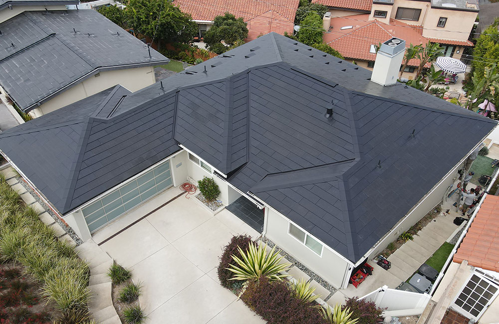 tesla-solar-roof-aerial-2 aerial view of a house in orange county with a tesla solar roof